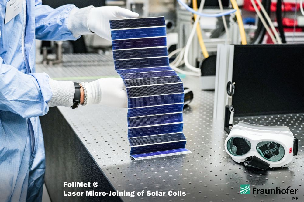 String of miniature solar cells connected in series using laser-welded aluminum foil.