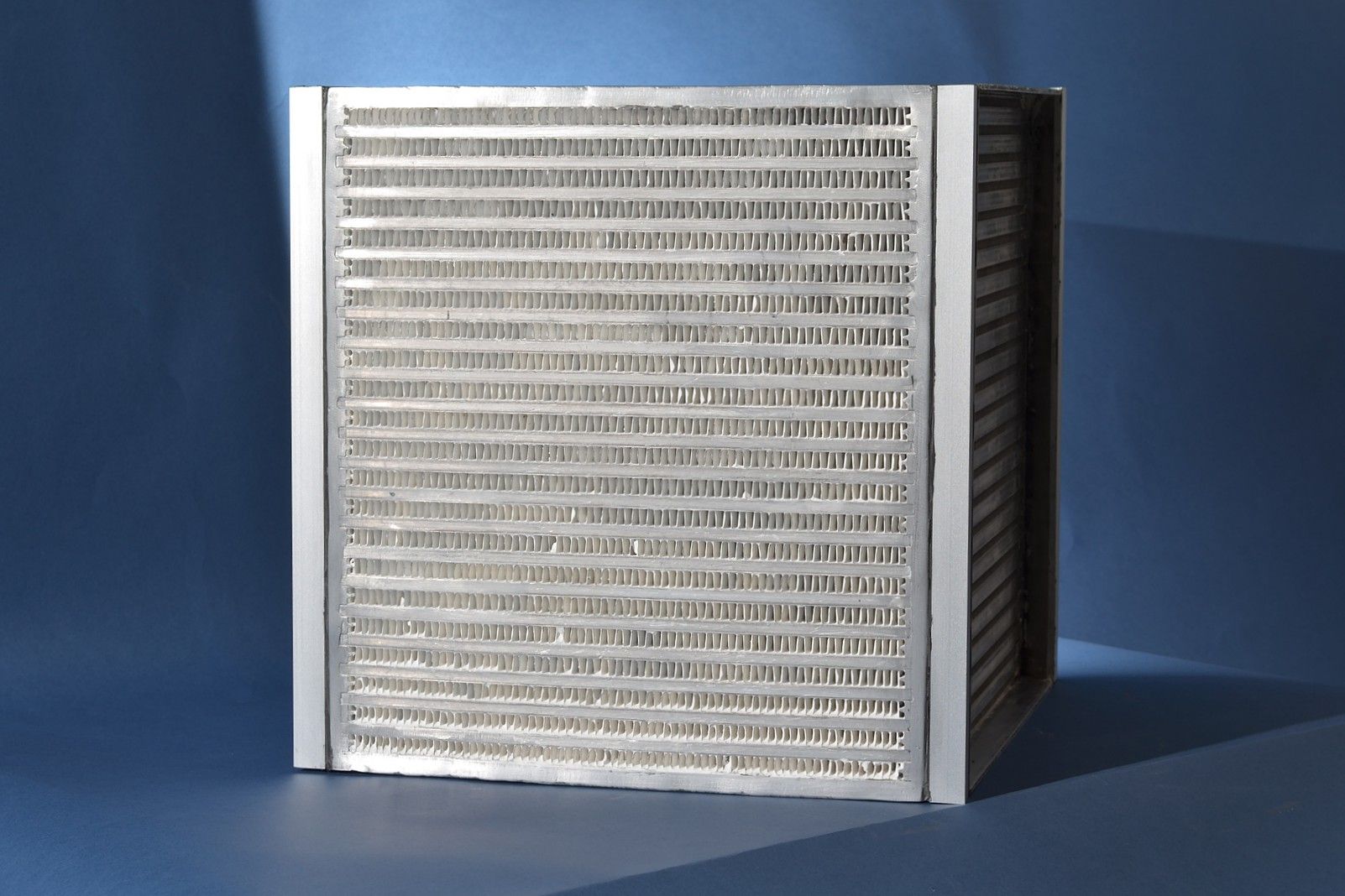 Industrial sized air-to-air heat exchanger with a binder-based coating using a zeolite-type material for the air-conditioning of buildings. 