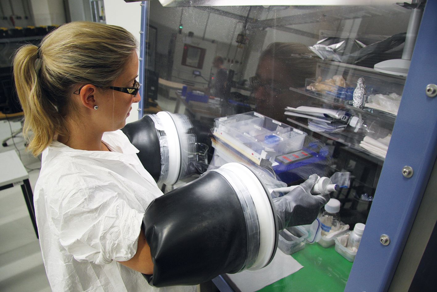 Employee working at a glove box at Fraunhofer ISE Employee working at a glove box at Fraunhofer ISE